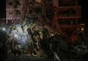 Israeli security forces inspect destroyed buildings that were hit by a missile fired from Iran (AP/Ohad Zwigenberg)
