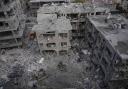 Israeli first responders work in a residential area near Tel Aviv, Israel, hit by a missile fired from Iran (Ariel Schalit/AP)