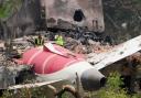 Officials inspect the site of Thursday’s Air India plane crash (Ajit Solanki/AP)