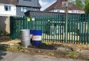 Oil drums left abandoned in Maybush