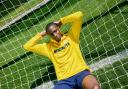 Joe Aribo models a new yellow training fleece with sponsor Midnite across the torso