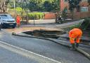 Southern Water workers at the sinkhole, hours after a man rode his bicycle over the hole and fell in.