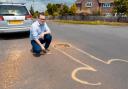 Cllr Jack Davies, member of New Forest District Council, next to the member drawn around the pothole