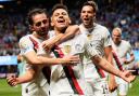 Manchester City’s Claudio Echeverri is congratulated by team-mates after scoring (Mike Stewart/AP)