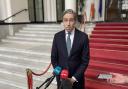 Tanaiste Simon Harris speaking to the media at Government Buildings (Grainne Ni Aodha/{PA)