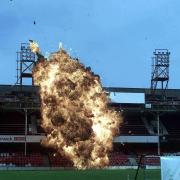 DEMOLITION AT THE DELL... PYROTECHNICS LIGHT UPTHE OLD STAND.