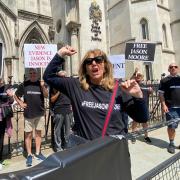 Sandra Dumont leads 'Justice for Jason' chants outside the Royal Courts of Justice in London's Strand, demanding the release of convicted killer Jason Moore