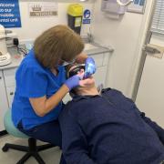 Dentist Mary Green treats a patient on the mobile dental unit