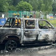 The burnt-out van has been left at the playing field in Hythe