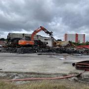 Images show the demolition of the site