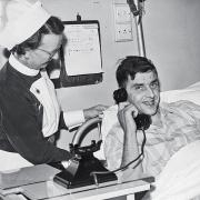Patient Richard Parrish makes the historic call with the assistance of ward sister B Jagger,