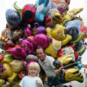 Milford on Sea carnival. Abbie Peckham buys a balloon from Keith Emery.