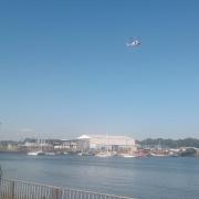 Coastguard helicopter flying over the Itchen River