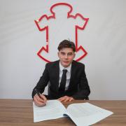 Jay Robinson has penned his first pro deal