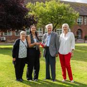 Paige Allen, centre left, and her adoptive mother Julie Allen, being presented with her bursary award by John and Marion Greenwood