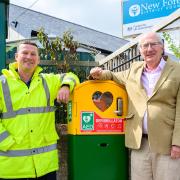 Richard Rastall, left, of ExxonMobil and Alan Alvey, chairman of Fawley Parish Council, with the new defibrillator at Calshot Road