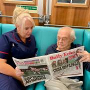 Mel Looker reading with a patient