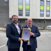 Mark Young, Deputy Director of Estates and Facilities, presenting the award to Richard Walker, Head of Facilities