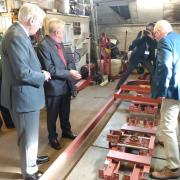 The Duke of Gloucester views parts of the railway carriage in which his uncle, King George VI, travelled along Hythe Pier in 1944