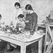 Women's Emergency Corps. Under the headline “Not Made In Germany” the pictures show the interior of the workroom of the Women’s Emergency Corps premises at Hanover Buildings as a party of keen workers are busily engaged in making toys of all