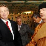 Dressing as terrorists is deemed inappropriate, such as Colonel Muammar Gaddafi, pictured right at a meeting with Tony Blair.