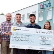 Caitlyn Sherry, Mountbatten Hampshire’s corporate partnership manager, received a cheque for the money at HWB's office