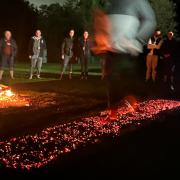 Business professionals confronted their fears by walking barefoot over red hot coals at an ‘Evolution Day’