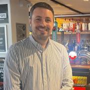 The Hunters Inn General Manager Ben Robbins standing in front of the bar.