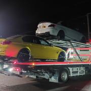 A yellow BMW and a white BMW were both seized