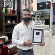 AK Grooming Room owner AK Serdar with his award for Hampshire's Best Barbers.