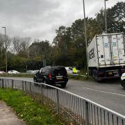 Delays as lorry crashes at roundabout - live updates