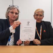 The signed covenant being held by Maggie MacIsaac, Chief Executive, and Lena Samuels, Chair, NHS Hampshire and Isle of Wight