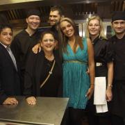 Housemates Carole (third left) and Kara-Louise (turquuoise dress) join owner Nikon Raftopoulos (left) and his kitchen staff at [one of] the opening night[s] of Ninety Degrees restaurant bar in Southampton. Photo: Andrew McCargow