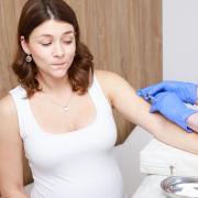 A pregnant woman receiving a vacination