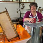 Penny Melville-Brown with a honey extractor