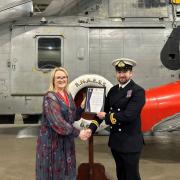 Worshipful Company of Fuellers, Junior Warden Louise Thompson presents the top academic award to and Lt Laurence Helmore