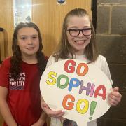 Sophia Hill, left, has been called 'an inspiration' for raising money for Lily Peacock, right, as she tries to raise money for an assistance dog.