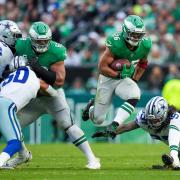 Philadelphia Eagles running back Saquon Barkley, with ball, is 100 yards short of Eric Dickerson’s NFL single-season rushing record of 2,105 yards (Matt Slocum/AP)