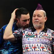 Peter Wright reacts to his fourth round victory over reigning world champion Luke Humphries at Alexandra Palace (Zac Goodwin/PA)