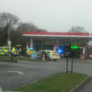 Four police cars were seen on blue lights entering a petrol station near Corfe Mullen on Christmas Eve.