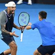 Nick Kyrgios (left) and Novak Djokovic celebrate during their doubles win over Alexander Erler and Andreas Mies in the Brisbane International (Darren England/AAP Image via AP)