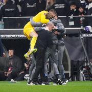 Guglielmo Vicario jumps on Tottenham boss Ange Postecoglou and his coaching staff at full-time after a 1-0 win over Eintracht Frankfurt (Bradley Collyer/PA)