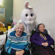 Court Lodge residents Irene Fraser and Sybil Skinner meet the Easter Bunny. 