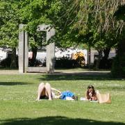 People enjoying the warm weather in Palmerston Park