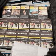 Police say that a total of 255 packets of cigarettes and 62 pouches of tobacco were seized, along with his car