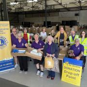 Boxes of hygiene items and food stacked for Ukraine-bound transport