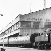 : One of the engines shunts three carriages alongside the port of Southampton’sformer great building the Ocean Terminal in 1962.