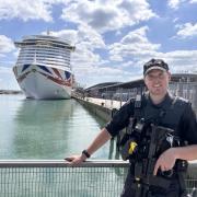 PS Max Preston stood next to Ocean Cruise Terminal as police explained why armed patrols are increasing.