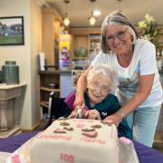 Stella cuts the cake with daughter Janice