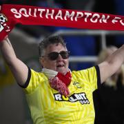 A Southampton supporter celebrates in the stands during an away fixture